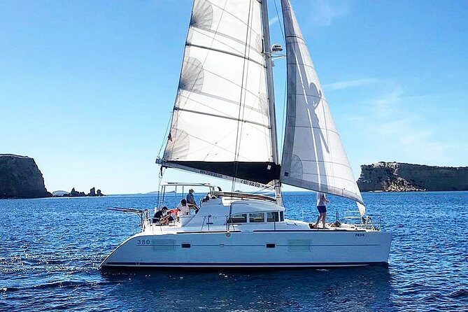 Cala Bassa Catamaran Private Excursion - Sunset in front of Café del Mar: the view payoff